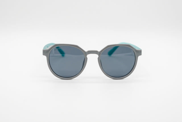 Gafas infantiles ACWIN Luna grises con patillas turquesa menta y montura geométrica hexagonal.