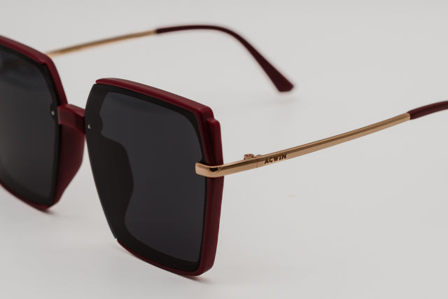 Detalle macro del acabado mate burdeos y la varilla dorada del modelo Melbourne.